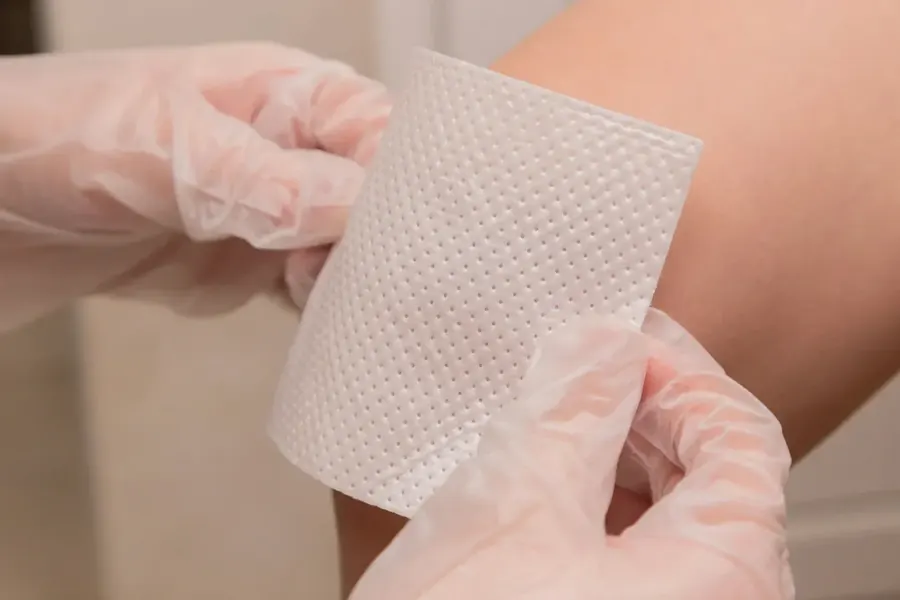 Dressing being applied to an arm